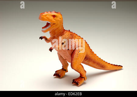 Spielzeug Dinosaurier auf Verlaufshintergrund Stockfoto
