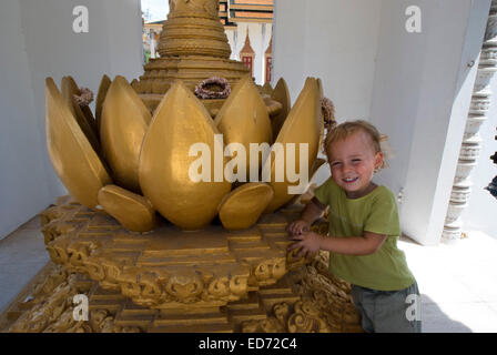 Kind posiert neben eine der Skulpturen und Statuen des Königspalastes. Phnom Penh. Kambodscha. Asien. Reisen Sie mit Kinder. Mädchen Stockfoto