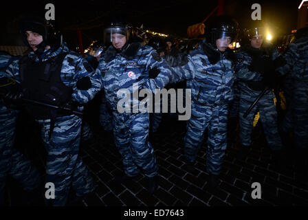 Moskau, Russland. 30. Dezember 2014. Russische Polizei drücken Demonstranten am Manezhnaya Platz in Moskau, Russland, am 30. Dezember 2014. Russische Aktivisten versammeln sich am Manezhnaya Platz in Moskau nach der Urteilsverkündung für Nawalny Brüder. Oppositionsführer Alexei Navalny bekam eine Bewährungsstrafe von 3,5 Jahren und sein Bruder Oleg bestellt wurde, zu eine Haftstrafe von 3,5 Jahren dienen. Sie haben der Veruntreuung von französischen Kosmetikfirma Yves Rocher schuldig gemacht. © Pavel Bednyakov/Xinhua/Alamy Live-Nachrichten Stockfoto