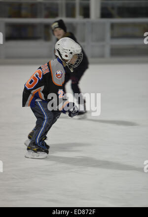 East Meadow, New York, USA. 31. Dezember 2014. Zwei jungen, einer trägt ein New York Islanders Eishockey Team Stil Hemd, Schlittschuhe, bevor ein 5 K New Year Eve DASH, der Long Island Rat über Alkoholismus und Drogen Abhängigkeit (LICADD) am Twin RInks Ice Center Eisenhower Park auf Long Island zu unterstützen Läufer teilnehmen. Ein Skatin' Silvester Eve Veranstaltung begann Stunden früher und ein New Silvester-Party, offen für Läufer, Familie und Freunde weiter bis 02:30 © Ann Parry/ZUMA Draht/Alamy Live News Stockfoto