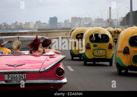 Touristen in einem Oldtimer Cabrio Buick entlangfahren Malecon in Havanna auf der Insel Kuba Stockfoto