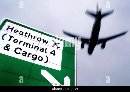 Ein Flugzeug fliegen über Verkehrszeichen in der Nähe von Heathrow International Airport, London. Stockfoto