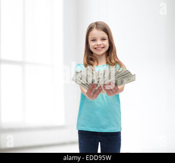 kleine Mädchen geben Dollar Bargeld lächelnd Stockfoto