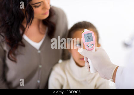 Arzt überprüft die Körpertemperatur der kleinen Patienten mit einem digitalen thermometer Stockfoto