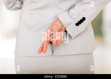 Geschäftsfrau mit Daumen hinter ihrem Rücken Stockfoto