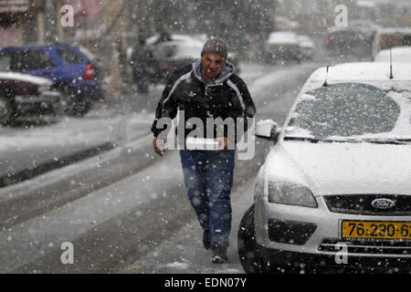 Jerusalem, Jerusalem, Palästina. 7. Januar 2015. Ein palästinensischer Mann betritt eine Straße während eines Schneefalls in Jerusalem am 7. Januar 2015. Wie starke Winde der Region zerschlagen und Temperaturen auf Null gesunken, Israel Polizei geschlossen die beiden Hauptzufahrtsstraßen in Jerusalem mehrere Stunden, bevor der Schnee fallen begann © Muammar Awad/APA Bilder/ZUMA Draht/Alamy Live News Stockfoto