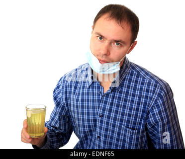 Mann in einer medizinischen Maske löst eine Pille Stockfoto