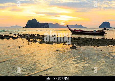 Native Boot am Strand und Sonnenaufgang morgen bei Trang, Thailand Stockfoto