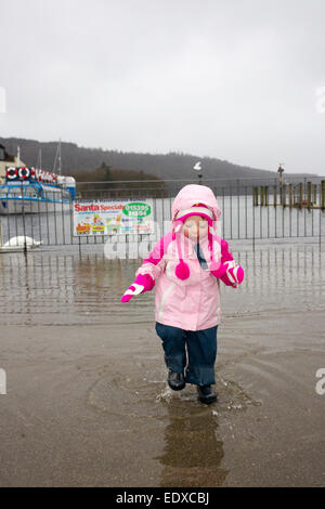 Lake Windermere, Cumbria, UK. 11. Januar 2015.  Lake Windermere Überschwemmungen über aber Touristen noch amüsieren. Niamh Hamill, Alter 2 aus Cheshire erfreut sich auf einen Tagesausflug mit ihren Eltern Credit: Gordon Shoosmith/Alamy Live News Stockfoto