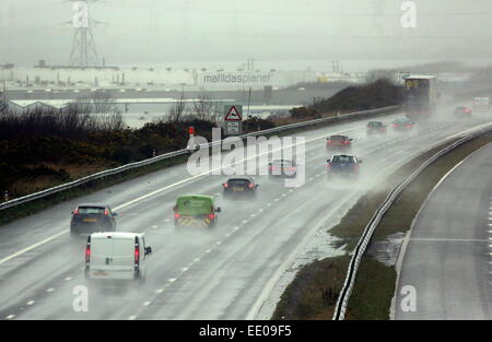 Pyle, UK. Montag, 12. Januar 2015 im Bild: Spray verursacht durch die M4-Autobahn in der Nähe von Pyle in Südwales Autos unterwegs.  Re: Leistungsstarke Jet-Streams bringen eine Reihe von Niederdruck Bereiche über den Atlantik verursacht stürmischen Wetterbedingungen in Teilen von der UK-Credit: D Legakis/Alamy Live News Stockfoto