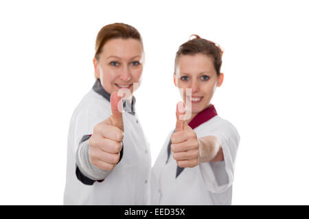 zwei Krankenschwestern, die mit Energie und Erfolg, isoliert auf weiss Stockfoto