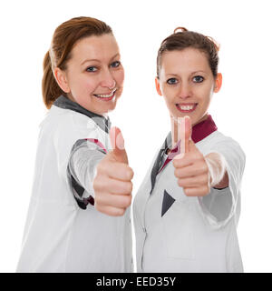 zwei weibliche Pflegekräfte zeigen, Energie und Erfolg, isoliert auf weiss Stockfoto