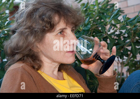 Frauen trinken Schnaps auf einer Terrasse an einem sonnigen Tag Stockfoto