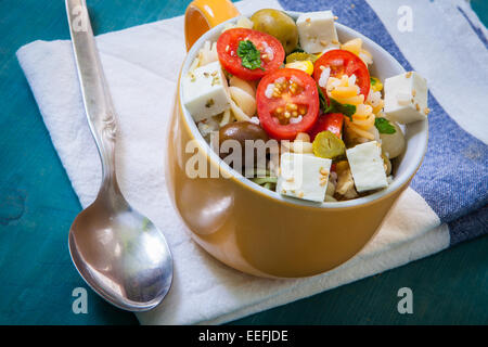 Nudelsalat mit Tomaten-Reis und Feta-Käse auf Schüssel Stockfoto