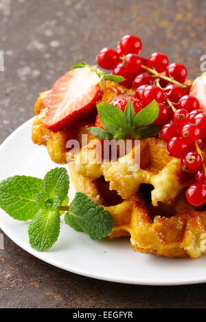 hausgemachte Waffeln mit Beeren (Johannisbeeren und Erdbeeren) Stockfoto