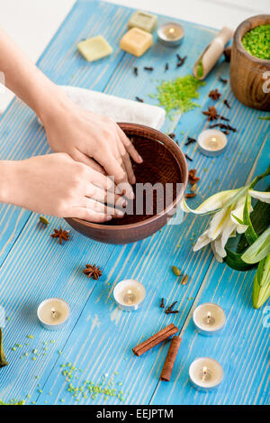 Einweichen Finger Nägel in die Wanne mit Wasser auf Holztisch mit Spa Zeug auf Hintergrund Stockfoto