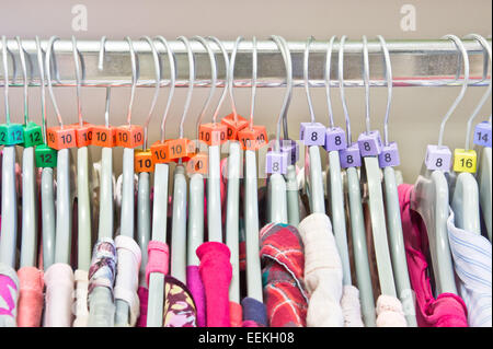 Lässige Tops auf Kleiderbügel in einem Charity-Shop Stockfoto