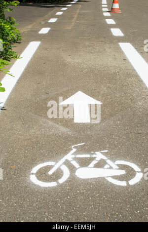 Frisch gestrichene Fahrrad Zeichen gesprüht auf Asphalt mit vorwärts-Pfeil Richtung angibt Stockfoto