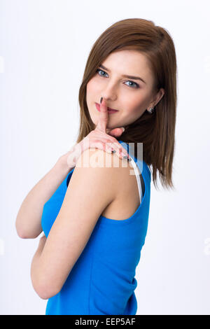 Schöne Frau mit geheim halten Finger über die Lippen Stockfoto