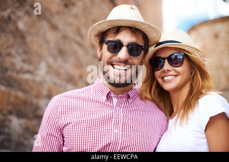 Glückliches Mädchen und ihr Freund in Hüte und Sonnenbrillen Stockfoto