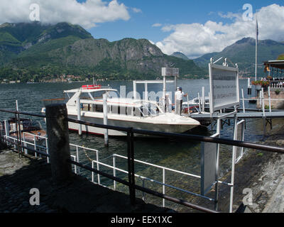 Wassertaxis am Steg in Bellagio am Comer See in Italien mit Blick auf den See und die umliegenden Berge Stockfoto