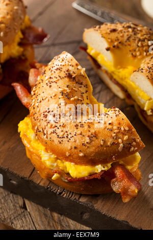 Herzhaftes Frühstück Sandwich auf einen Bagel mit Ei, Speck und Käse Stockfoto