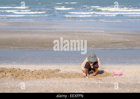 Das Leben ist ein Strand - Thai-Frau Kommissionierung Muscheln am Strand im Dolphin Bay, Prachuap Khiri Khan, Thailand. Stockfoto