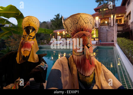 Traditionelle Phi Ta Khon-Festival Maske von carved Coconut Tree Trunk verzieren das Schwimmbad von Phunacome Resort in Dan Sai im westlichen Teil der Provinz Loei, Northeastern Thailand gemacht Stockfoto