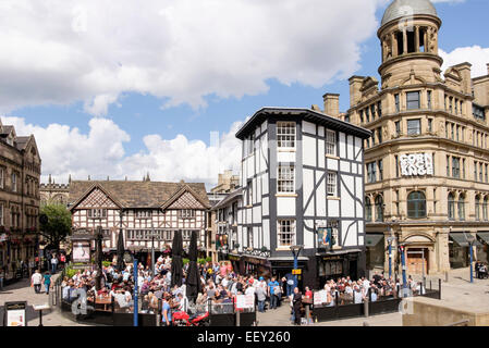 Das Old Wellington Inn 1552-Fachwerkgebäude aus dem 16. Jahrhundert mit Menschenmassen im belebten Biergarten. Manchester England Großbritannien Stockfoto