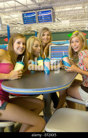 Freundinnen an einem Tisch in einer Bowlingbahn Stockfoto