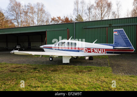 Privatflugzeuge Mooney M20J "201" geparkt vor grünen Hangar in Celle, Deutschland Stockfoto