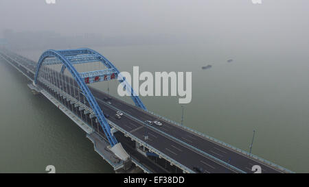 Hangzhou. 26. Januar 2015. Luftbild, aufgenommen am 26. Januar 2015 zeigt eine Brücke eingehüllt in Smog über Qiantang-Fluss in Hangzhou, Hauptstadt der ostchinesischen Provinz Zhejiang. Die Stadt Luft Qualität Index (AQI) lesen um 14 Uhr Montag war 258. Viele Teile der Provinz ausgestellt gelb und orange Alert für Smog Montag. Bildnachweis: Xu Yu/Xinhua/Alamy Live-Nachrichten Stockfoto