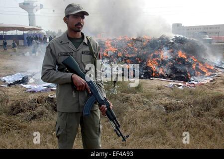 Lahore, Pakistan. 26. Januar 2015. Ein pakistanischer Soldat steht Wache neben Drogen und Alkohol während einer Zeremonie International Customs Day in Lahore, Pakistan, am 26. Januar 2015 brennen. Bildnachweis: Sajjad/Xinhua/Alamy Live-Nachrichten Stockfoto