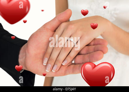 Zusammengesetztes Bild des zugeschnittenen Bildes der frisch vermählte Paar Hand in Hand Stockfoto