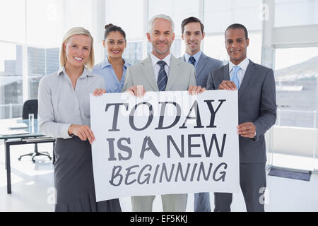 Zusammengesetztes Bild Business Teams halten große leeres Plakat Stockfoto