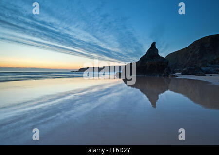 Eine coole blaue Farbe nach Sonnenuntergang wirft seine Reflexion auf dem nassen Sand am Strand von Bedruthan. Stockfoto