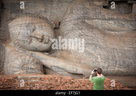 TOURIST AM RIESIGEN LIEGENDEN BUDDHA SÜNDE NIRVANA; GAL VIHARA FELSENTEMPEL Stockfoto