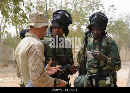 Ein US-Marine Spezialoperationen Instructor Slips Senegal und Mali Anti-Terror-Team-Mitglieder auf Bewegung Taktik vor der Durchführung von Anti-Terror-Operationen in urbanem Gelände Umgebung während des Trainings 14. Mai 2010 in Theis, Senegal. Stockfoto