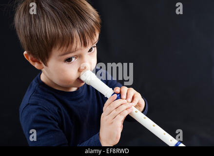 Junge spielt einen recorder Stockfoto