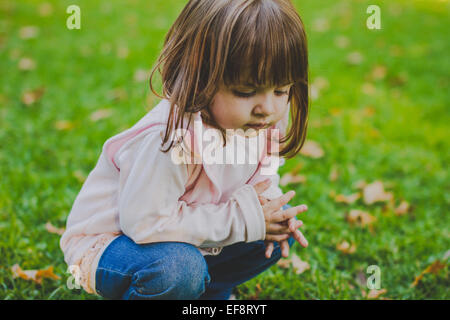 Porträt eines Mädchens hocken in einem öffentlichen Park Stockfoto