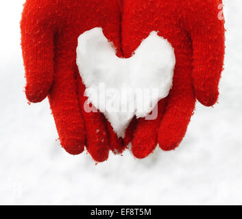 Finnland, Nahaufnahme von Frau mit Herz aus Schnee gemacht Stockfoto