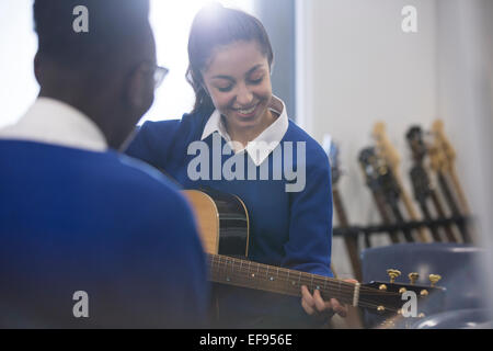 Studenten, spielt akustische Gitarre im Klassenzimmer Stockfoto