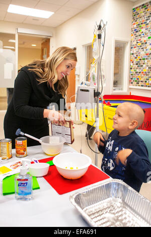 Ein Kind Leben Specialist bei CHOC Kinderkrankenhaus in Orange, CA, hilft ein Krebspatient Chemotherapie eine Kürbis Dessert zu machen. Kind Leben Spezialisten unterstützen Patienten und Familien im Krankenhausumfeld. "Beachten Sie intravenös zu verabreichenden Baum." Stockfoto