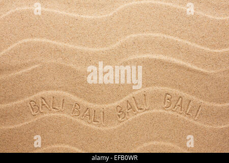 Bali-Inschrift auf dem welligen Sand als Hintergrund Stockfoto