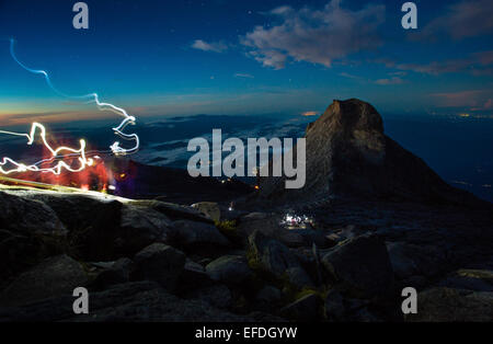 Lichtspuren von Stirnlampen von Kletterern nahe dem Gipfel des Mount Kinabalu kurz vor der Morgendämmerung - Sabah Borneo Stockfoto