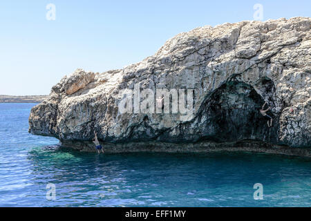 Einheimische und Urlauber genießen den Nervenkitzel des Klettern und springen in der Ost-Mittelmeer, Zypern. Stockfoto