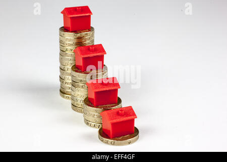 Roten Monopol Häuser auf Pfählen der Pfund-Münzen. Stockfoto