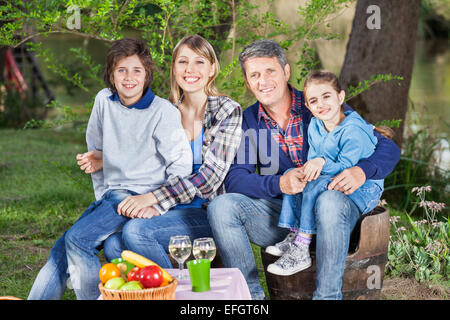 Familie sitzen auf Stühlen auf Campingplatz Stockfoto