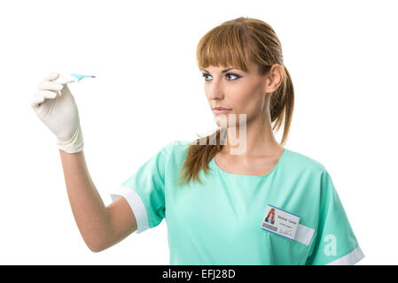 Schöne Krankenschwester beobachtete thermometer Stockfoto