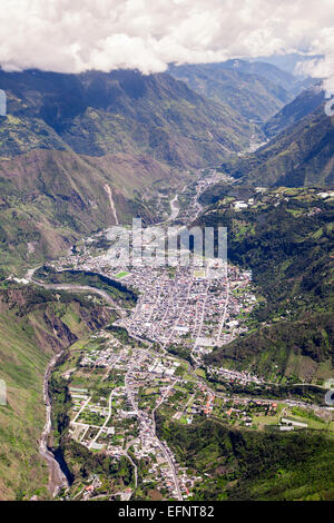 Ein Luftbild zeigt eine dicht bebaute Stadt, eingebettet in ein schmales Bergtal. Die Siedlung ist von steilen, üppigen grünen Hügeln mit sichtbaren Terrassenfeldern und Vegetationsflächen umgeben Stockfoto